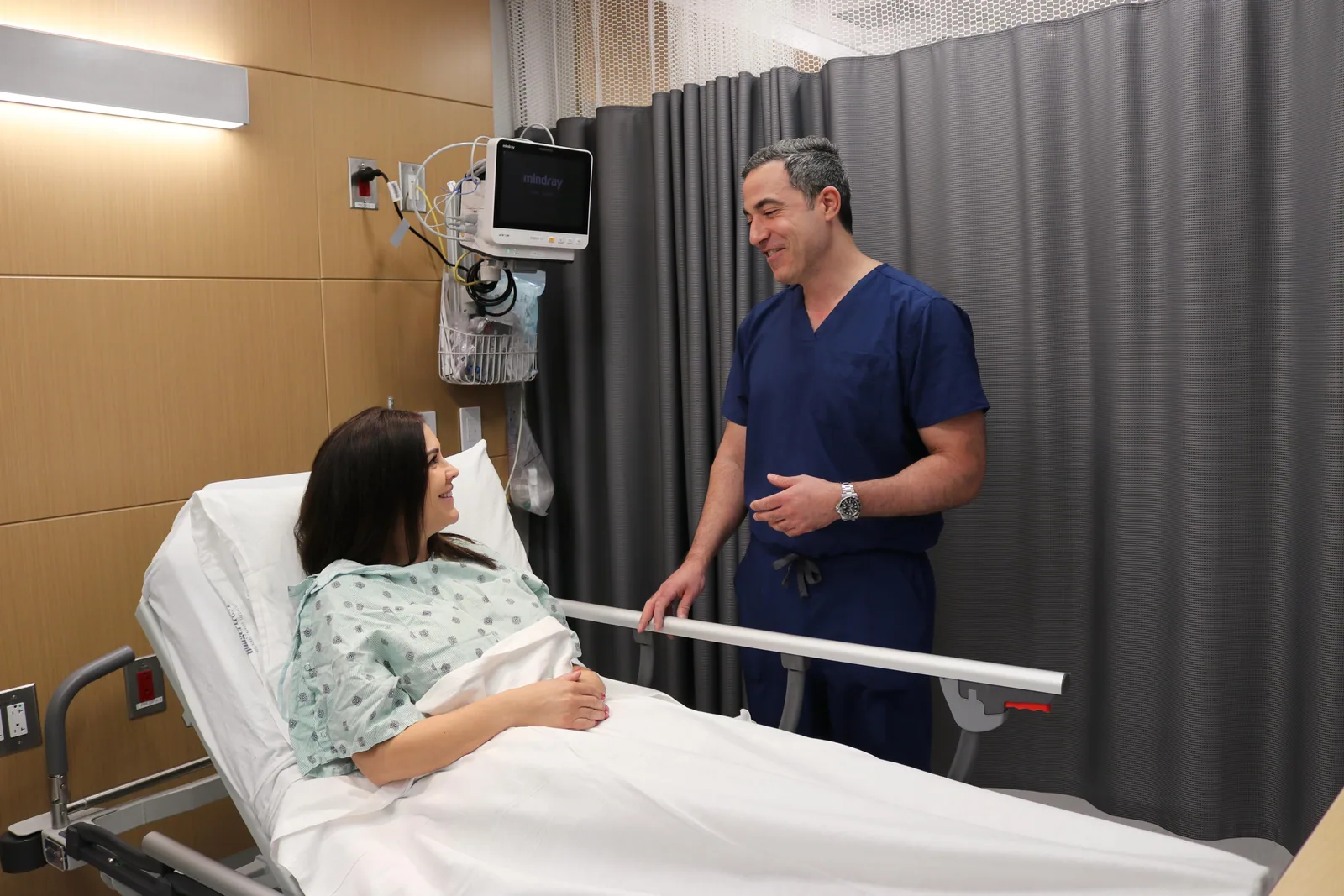 Dr. Yasmeh explaining a spine condition to a patient at the bedside