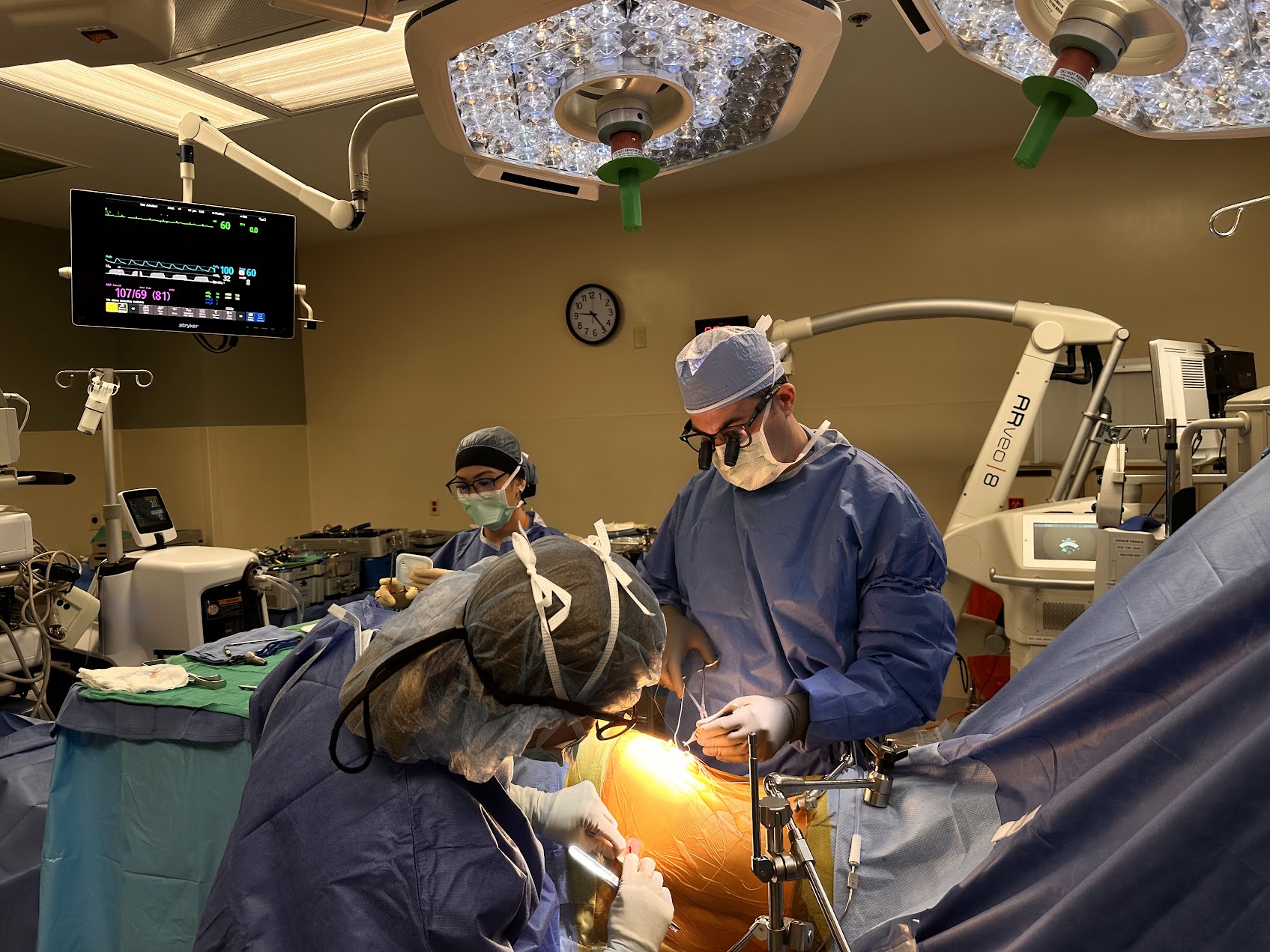 Patient holding lower back, evaluating whether back surgery is needed